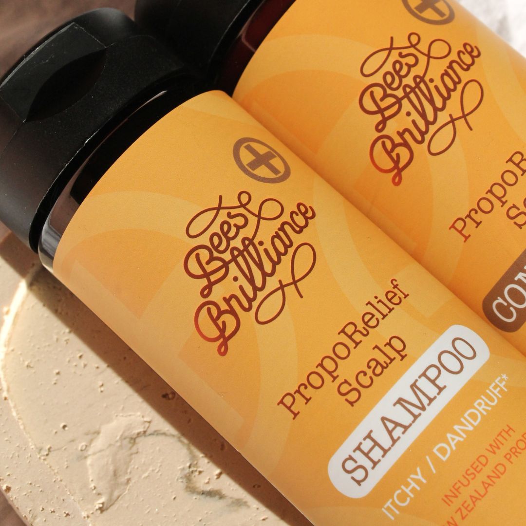 Two bottles of 'Best Brilliance' Propolis Relief Shampoo and Conditioner on a white background